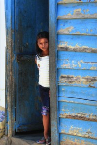 Little girl looking out door