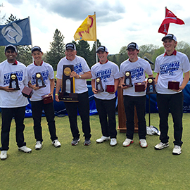 CMS golf players on green lawn with trophies