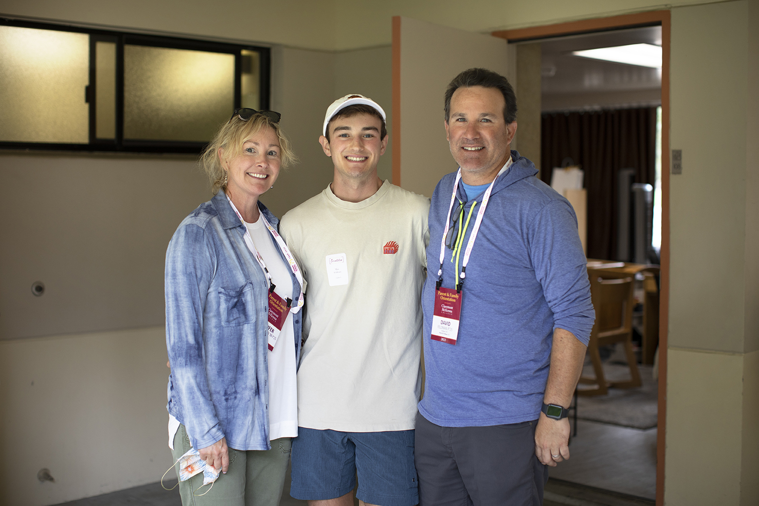 Max Feldman ’25 stands between his parents outside his dorm