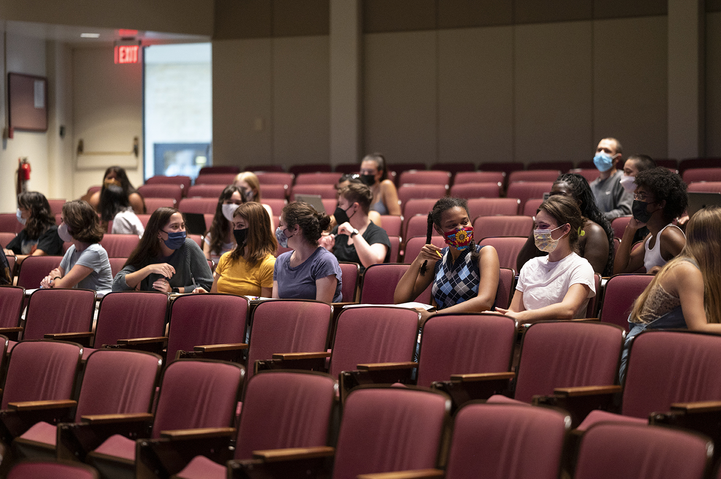 Rows of scattered students sitting in the auditorium-style lecture hall of Professor Aditi Vyas' class