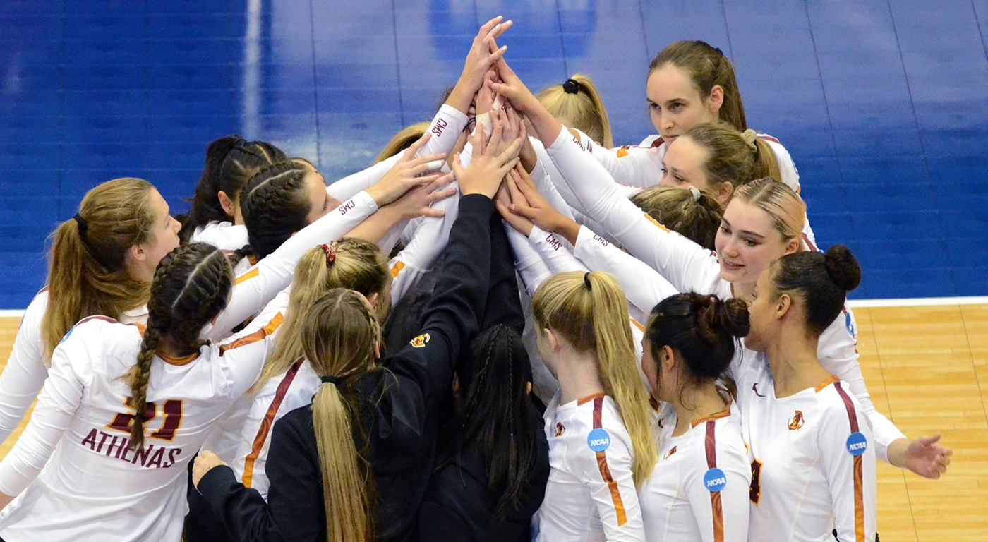 CMS Athenas Voleyball Team come together for a team huddle on the court.