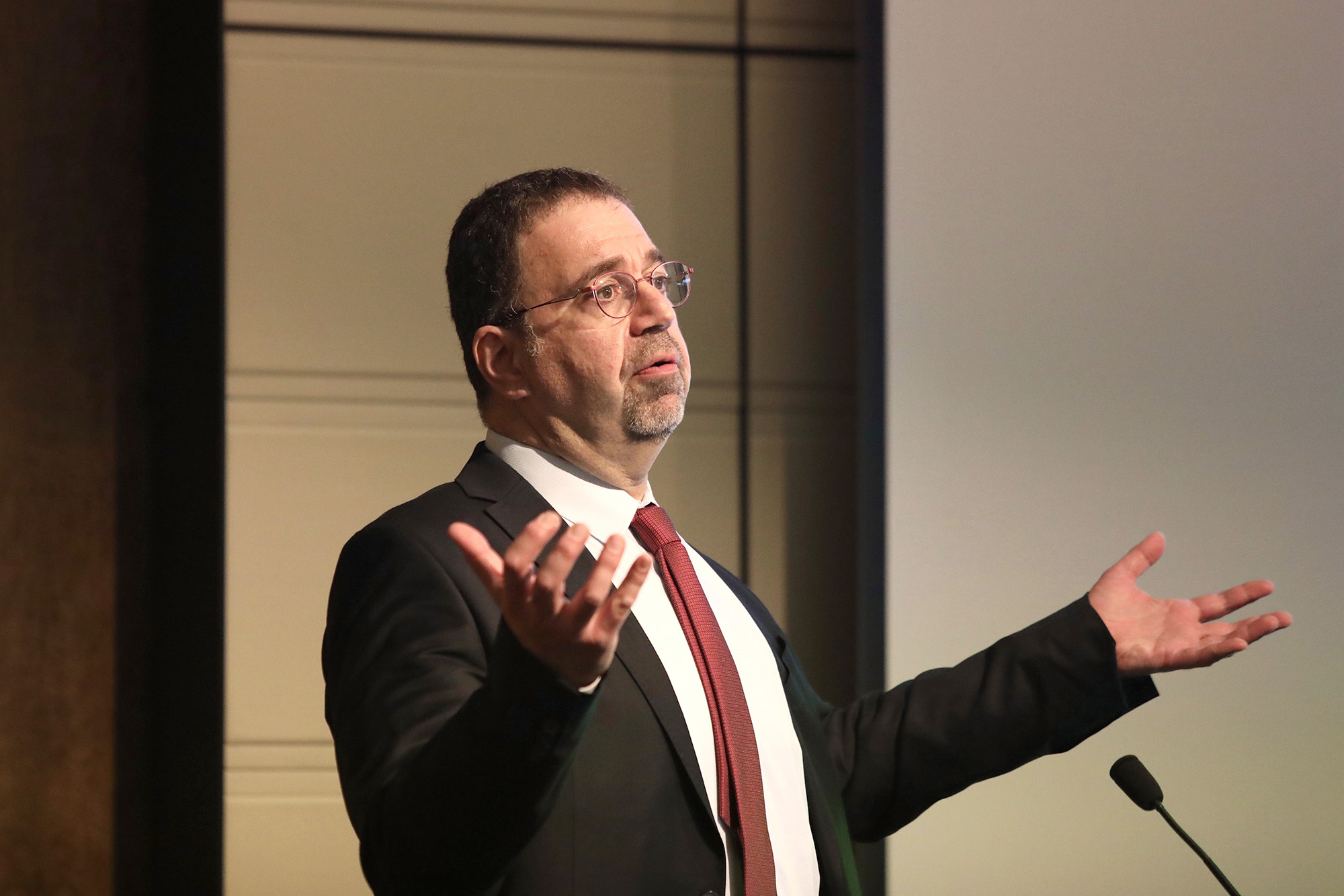 MIT Prof. Daron Acemoglu at the podium on the Athenaeum stage.