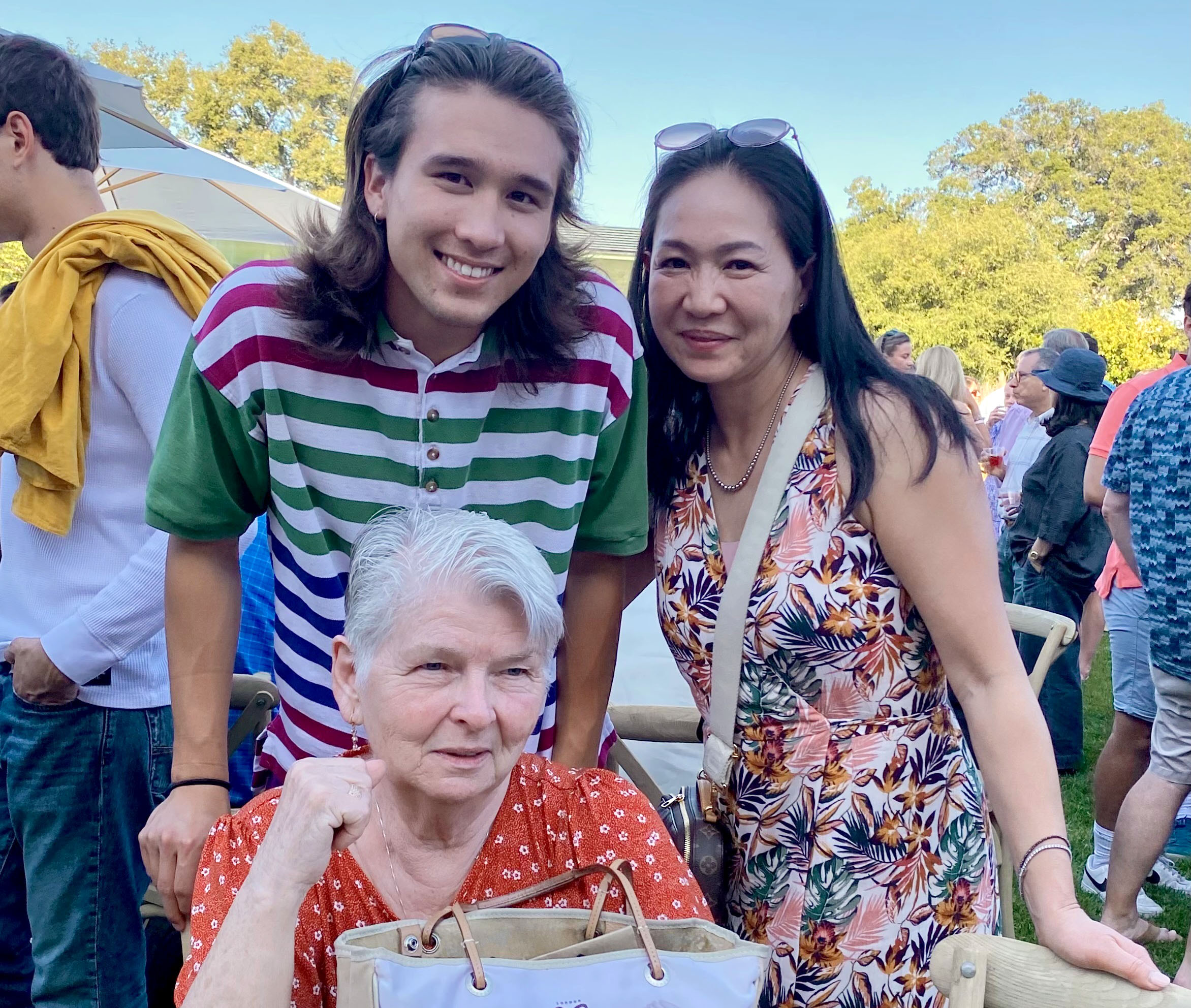 Max Proctor ’22 and his mother stand behind his seated grandmother at CMC's 2022 Commencement.