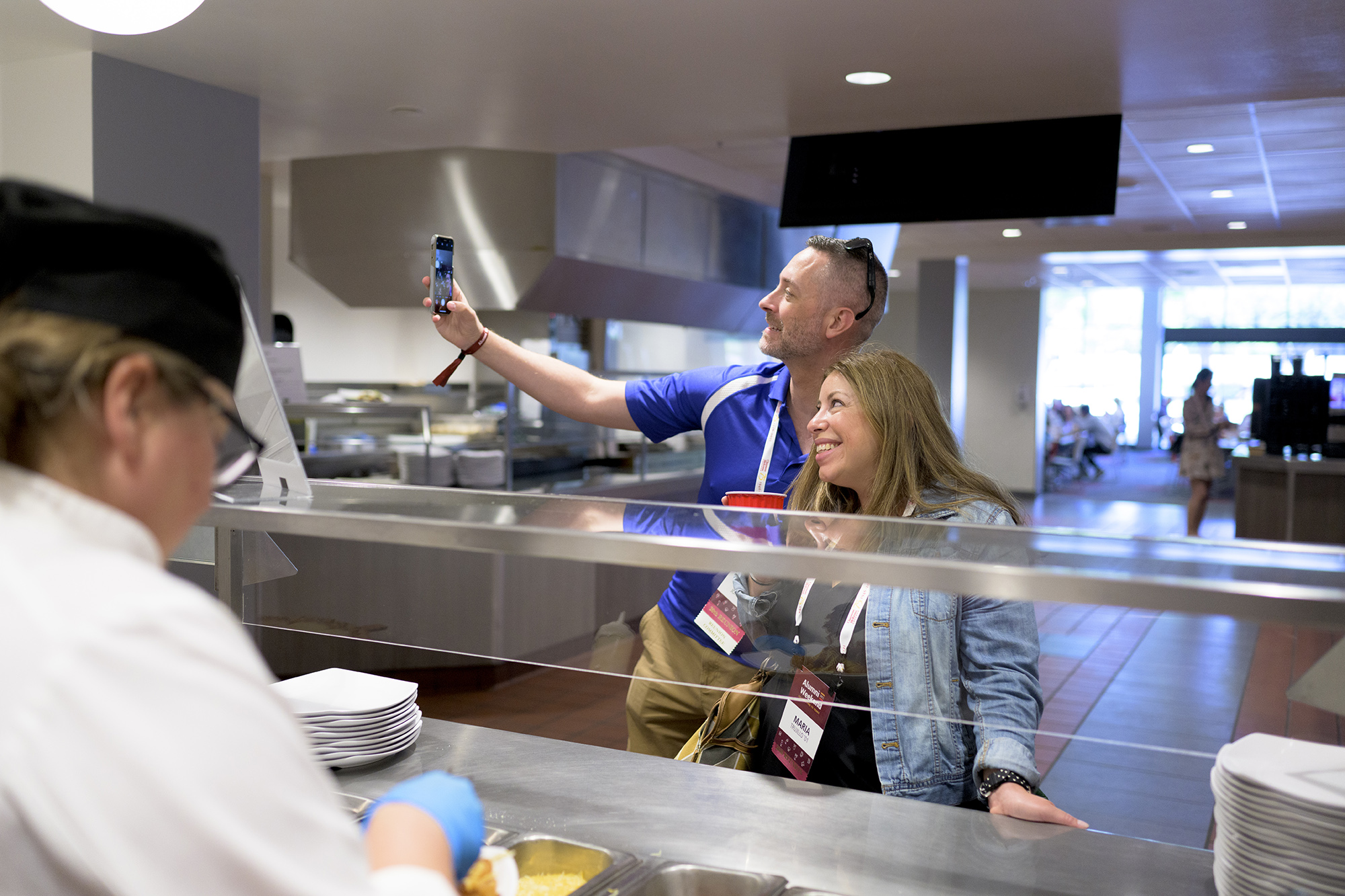 Richard Johnson '01 takes a selfie with a fellow CMCer while waiting for their plates inside Collins Dining Hall.