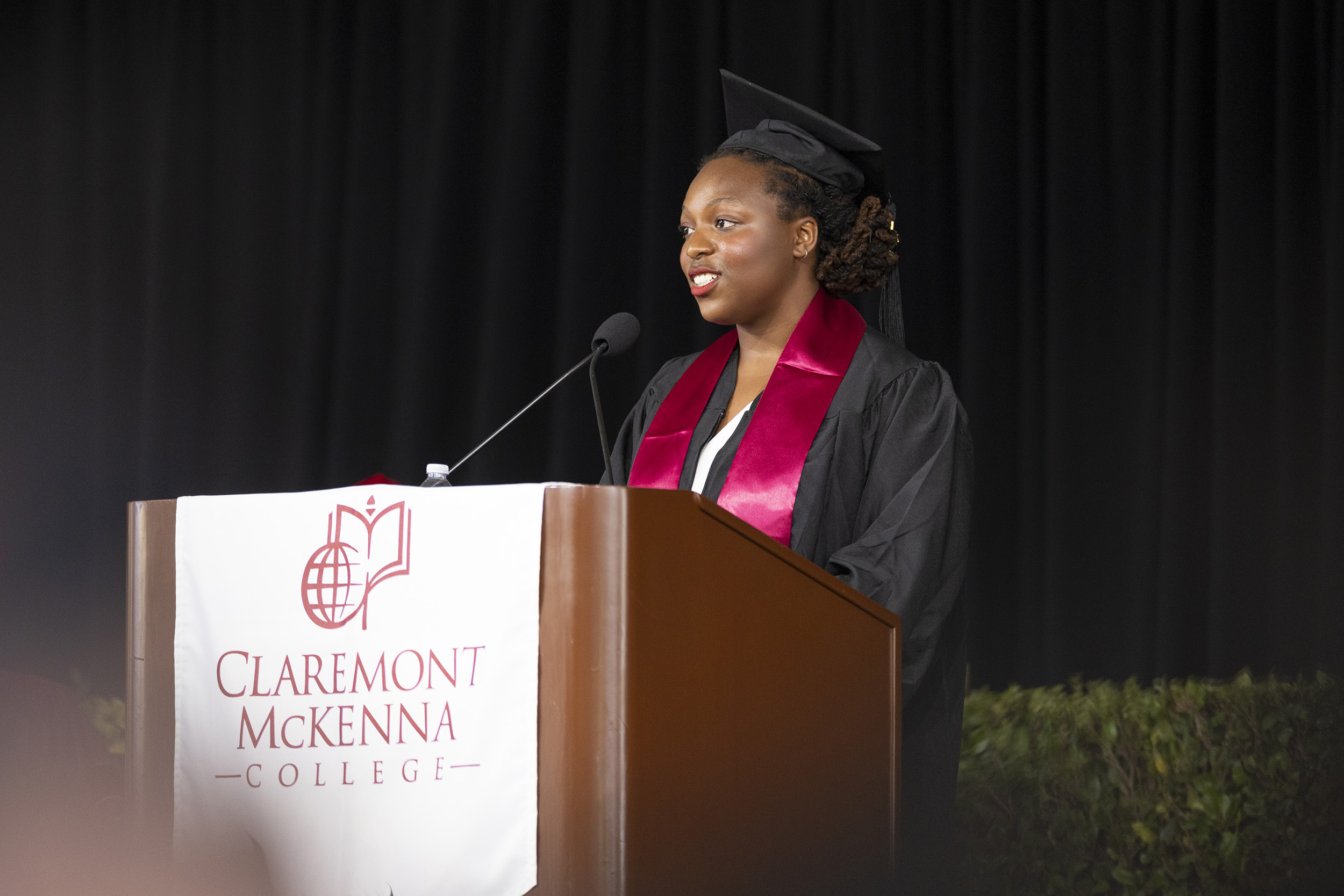 JaDa A. Johnson ’21 on stage at commencement for the classes of 2020 and 2021 to introduce the class-elect speaker, Maya Victoria-Rosetta Love ’20.