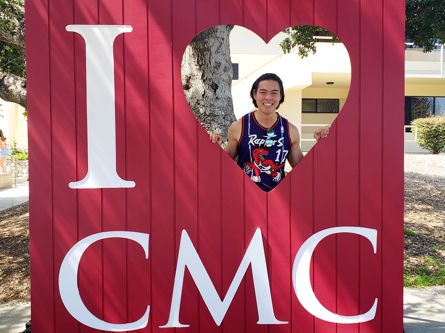 Kiubon Kokko’21 takes his turn using the "I [heart] CMC" photo prop frame.