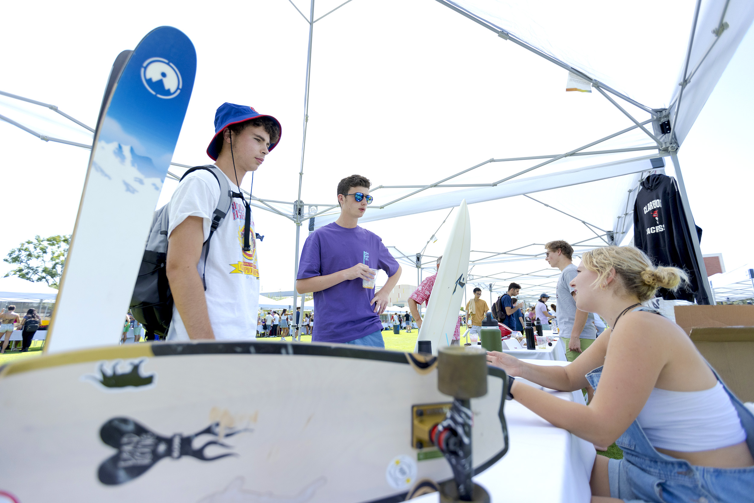 Students Charles Caiatti '26 and Clancy Strains '26 check out the Outdoor Initiative booth