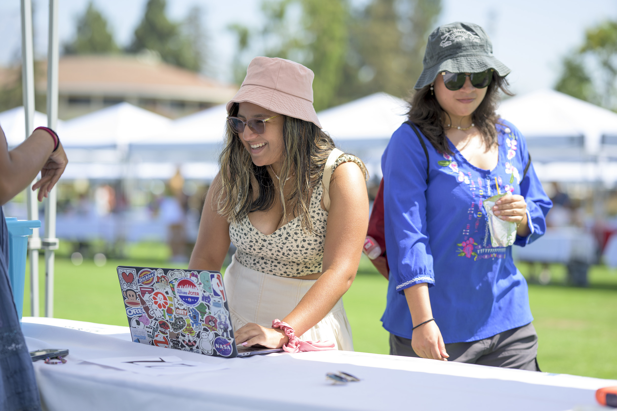 Daniella Reyes ’26, left, and Alex Perez ’26 visit the Mock Trial booth to learn about skill-building