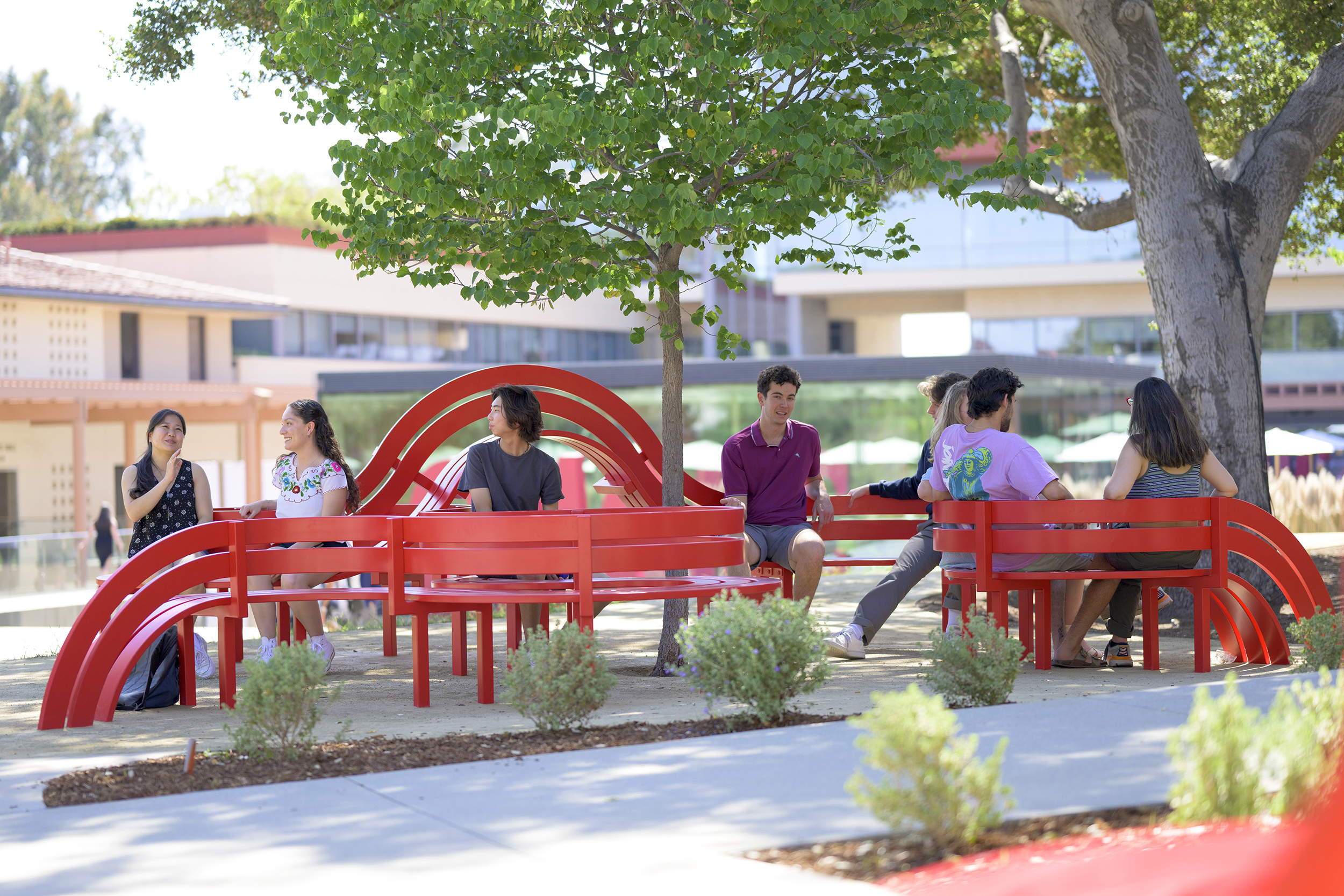 Students sitting on Jeppe Hein benches.