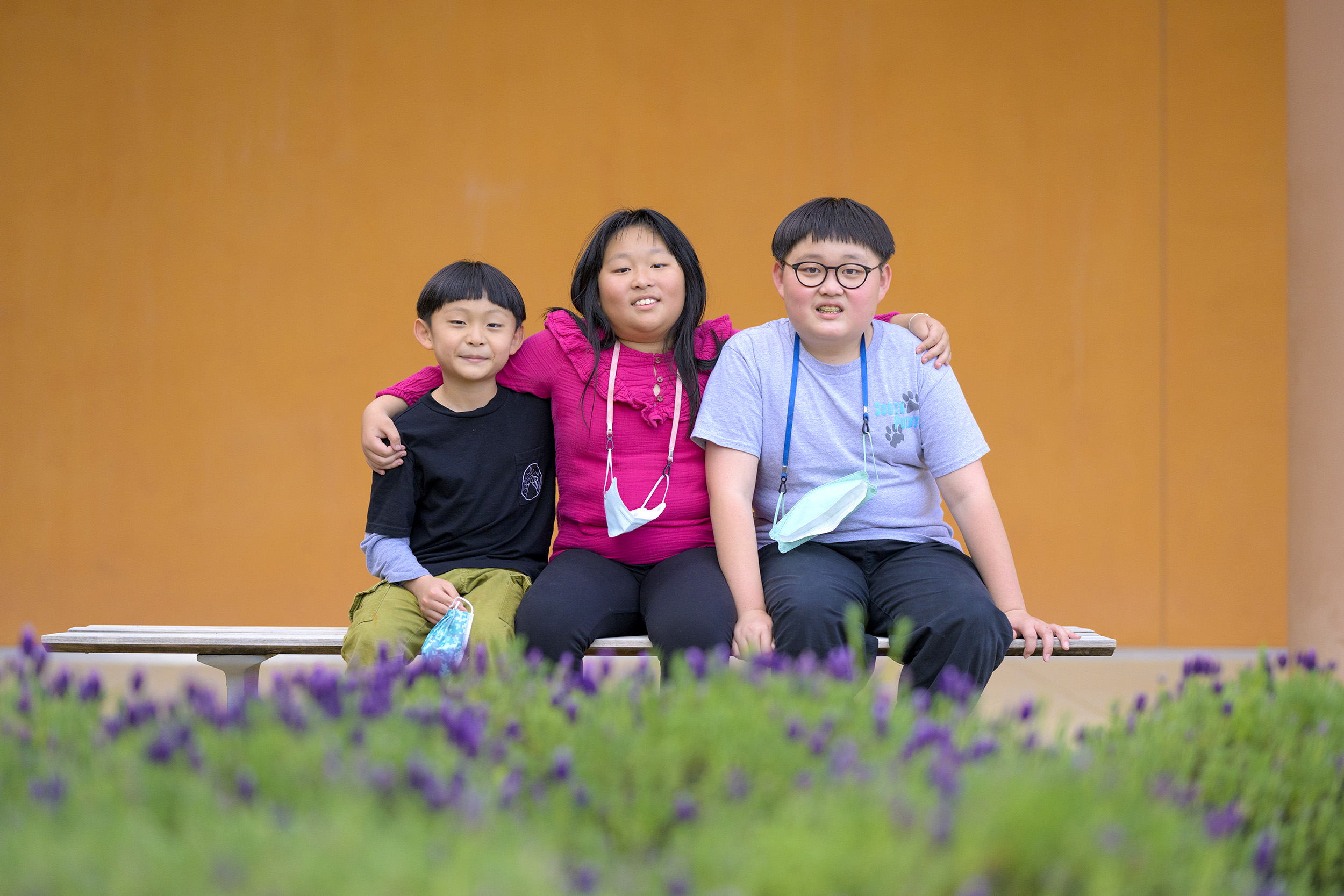 A family of participants sit together on a bench after a group activity.