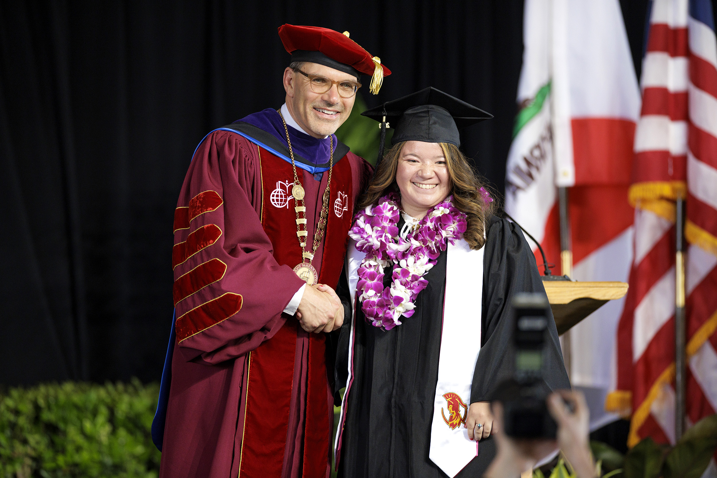 President Chodosh with a graduate..