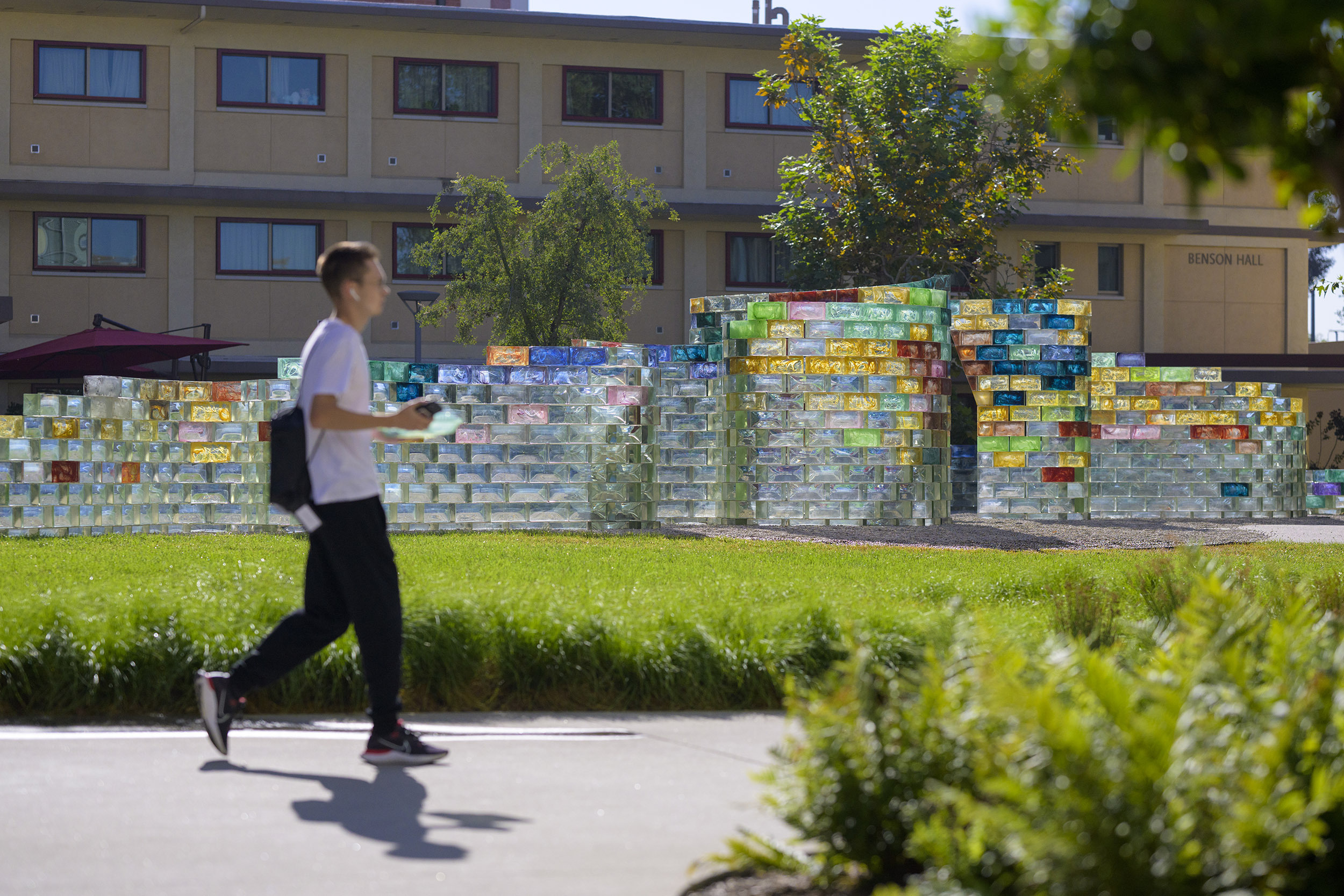 A student passes CMC's newest art piece, Qwalala, during the first week of school.