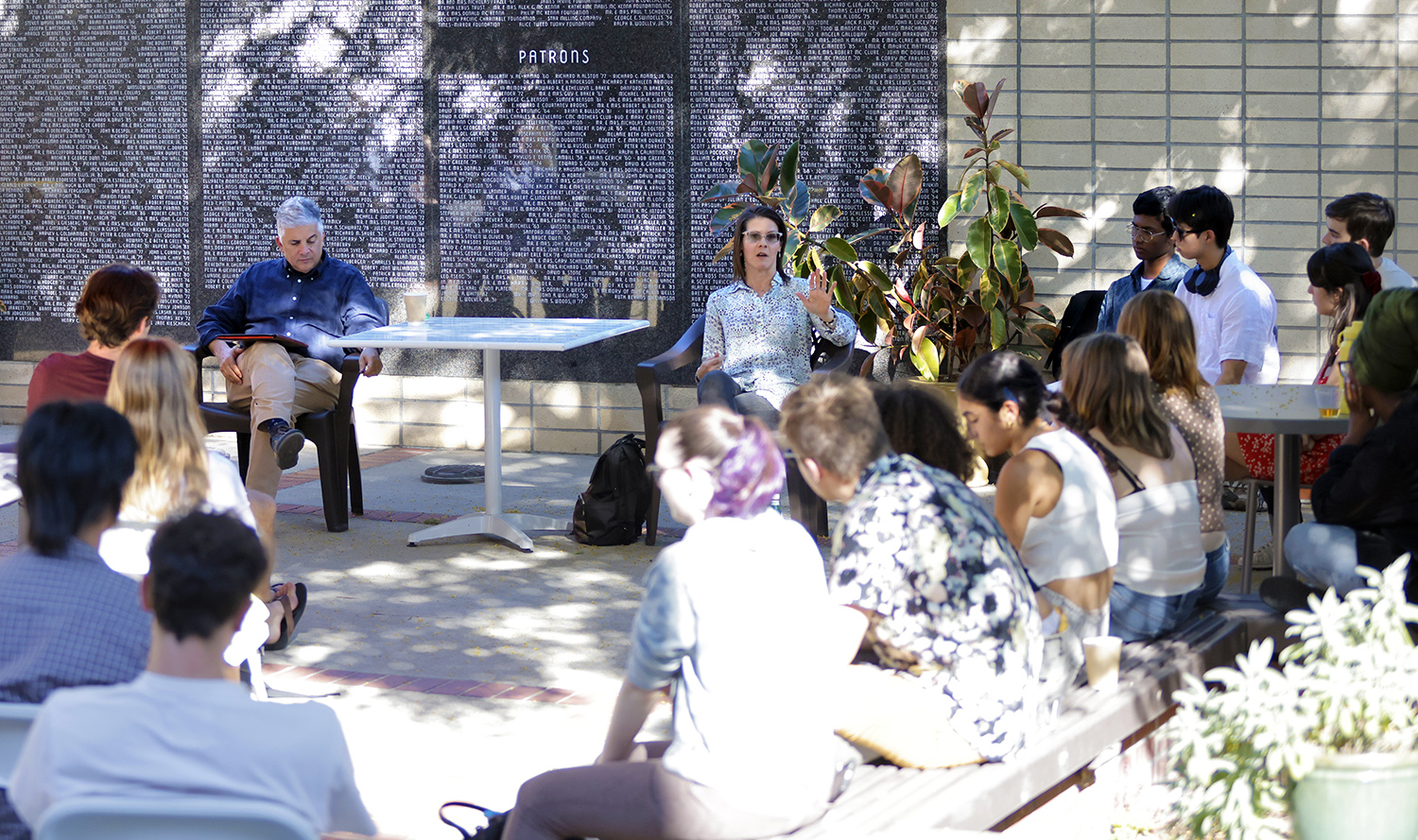 Professor Heather Fergueson speaking to students on the Athenaeum courtyard.