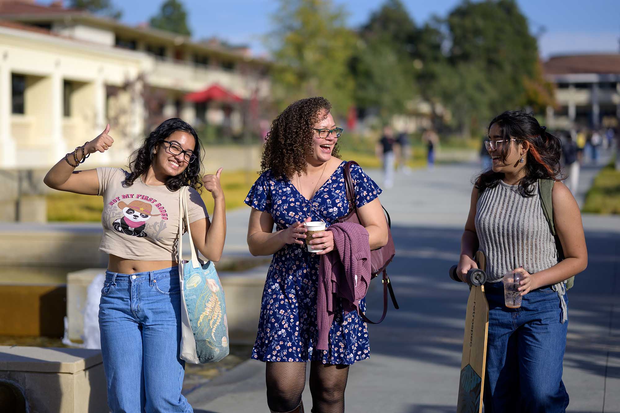 Professor Briana Toole walking with two students on the first day of the Spring 2024 semester.