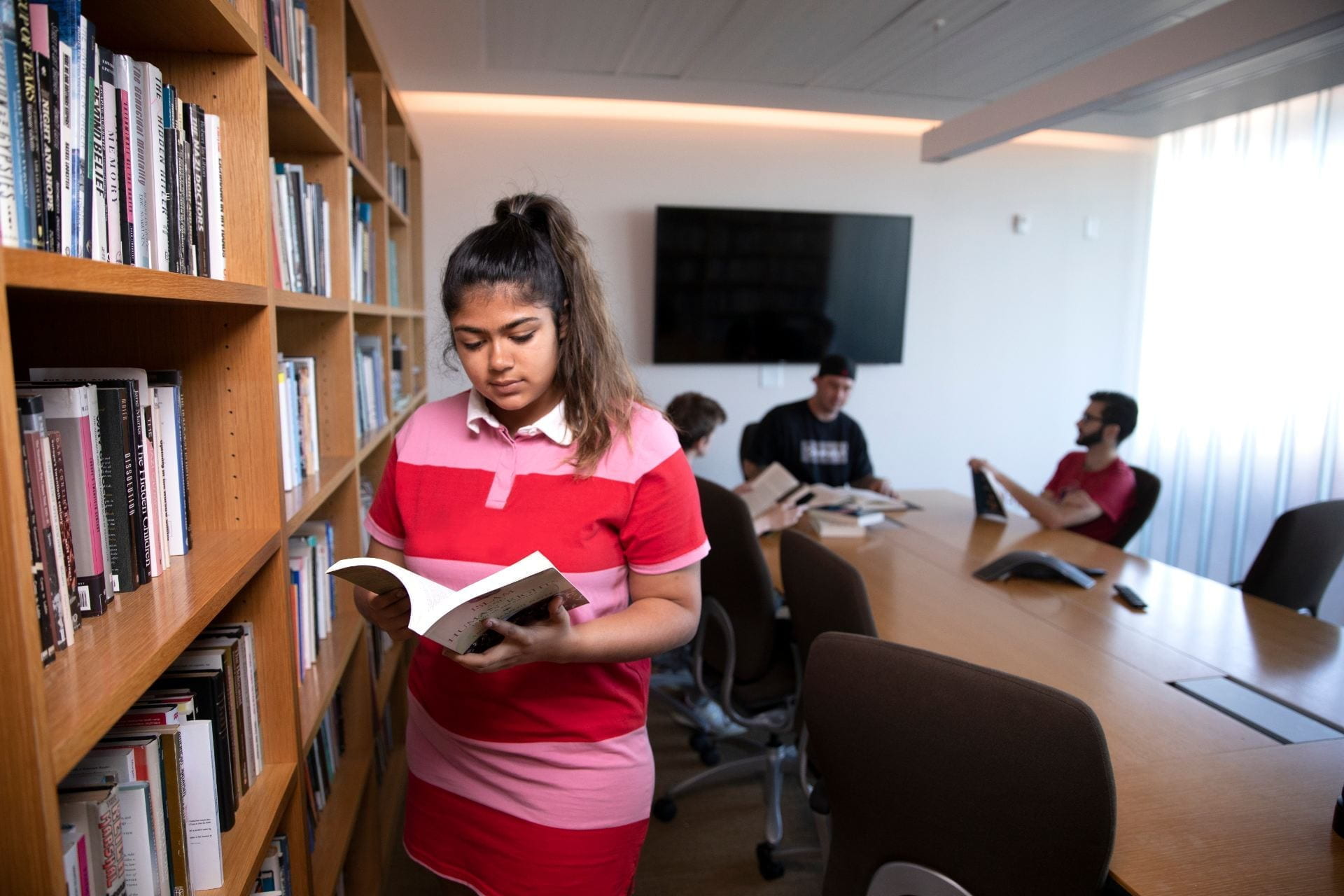 A female student reading in the Mgrublian Library.