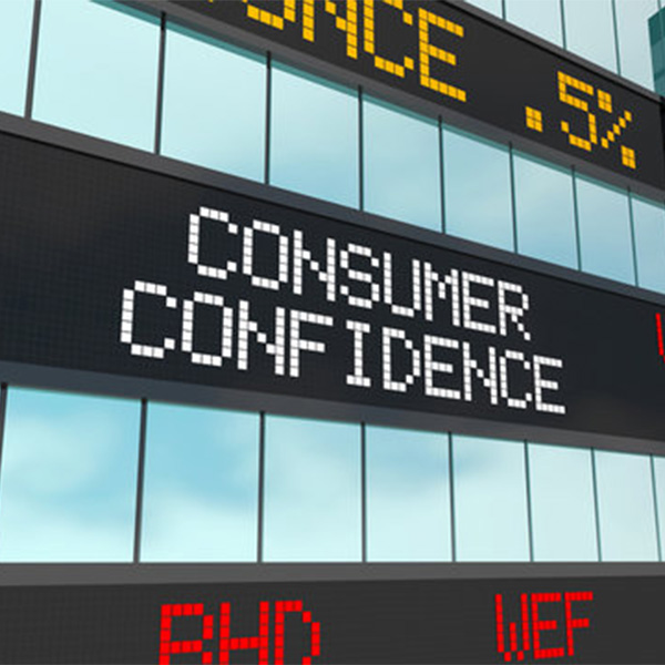 Digital screen displaying 'Consumer Confidence' and stock market rates.