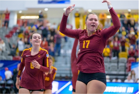 Athenas volleyball players celebrating in Roberts Pavilion during the NCAA Division III Volleyball Championship tournament.