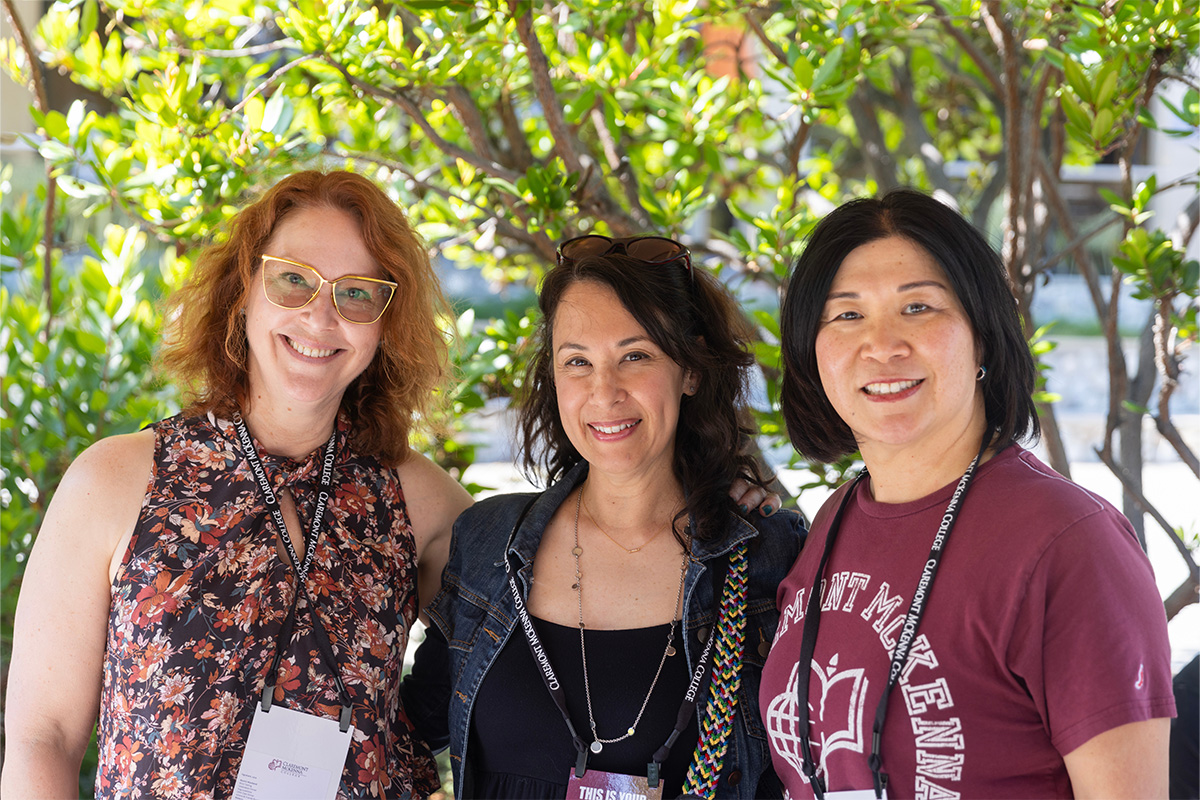 Three alumni posing together.