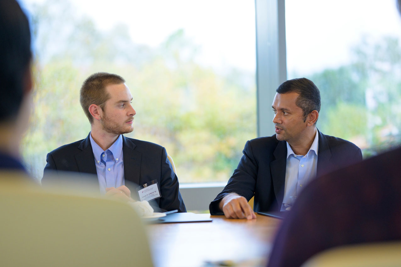 Student George Ashford'25 and board member, Sunil Rajaraman talking.