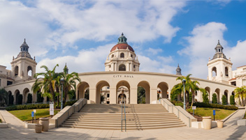 Stair entrance to a city hall and surrounding buildings.