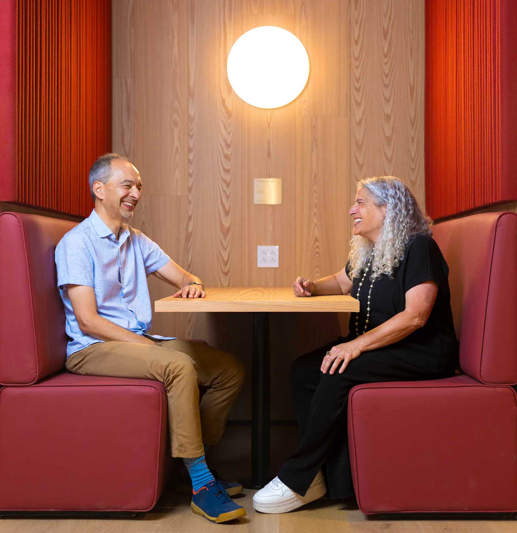 Professors Ran Libeskind-Hadas (left) and Heather Antecol, Dean of Faculty, enjoy a moment in an RDSC booth.