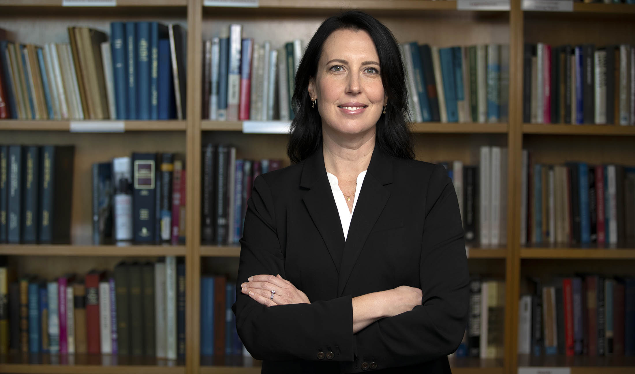 Prof. Shanna Rose in front of bookcase