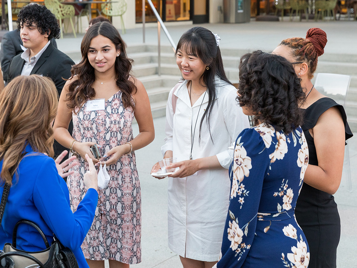 Female students speaking with an alumni during ImpactCMC.