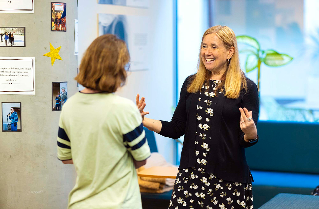 Professor Amy Kind speaking with a student.