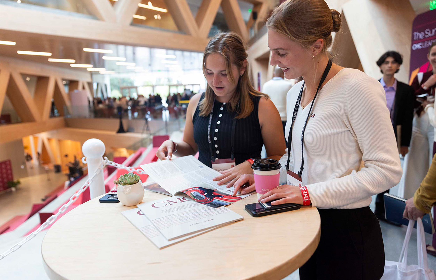 Two students look through the Spring 2026 CMC Magazine at The Summit.