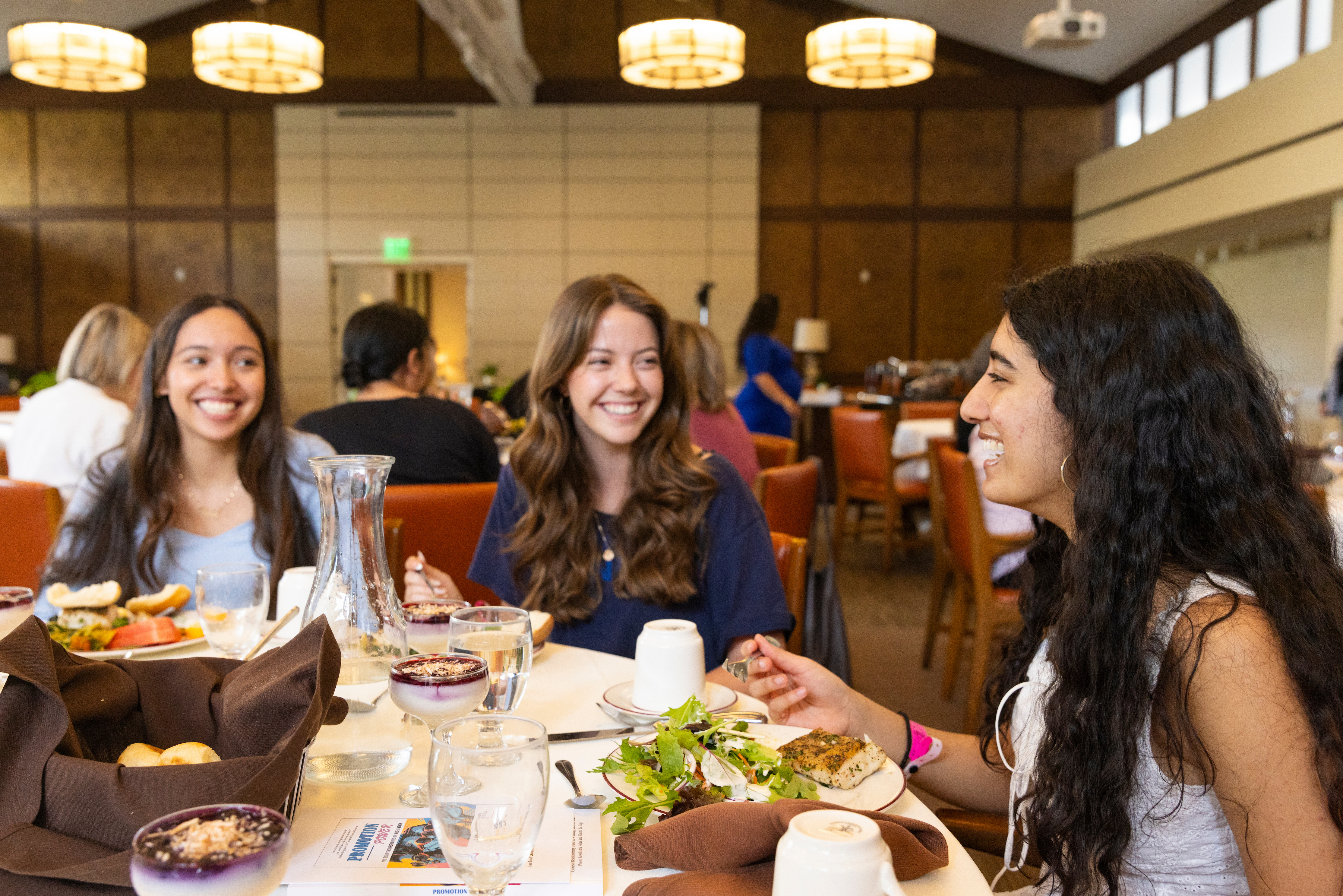 CMC students share a table in the Ath dining room during 2026 Women and Leadership Alliance Conference.