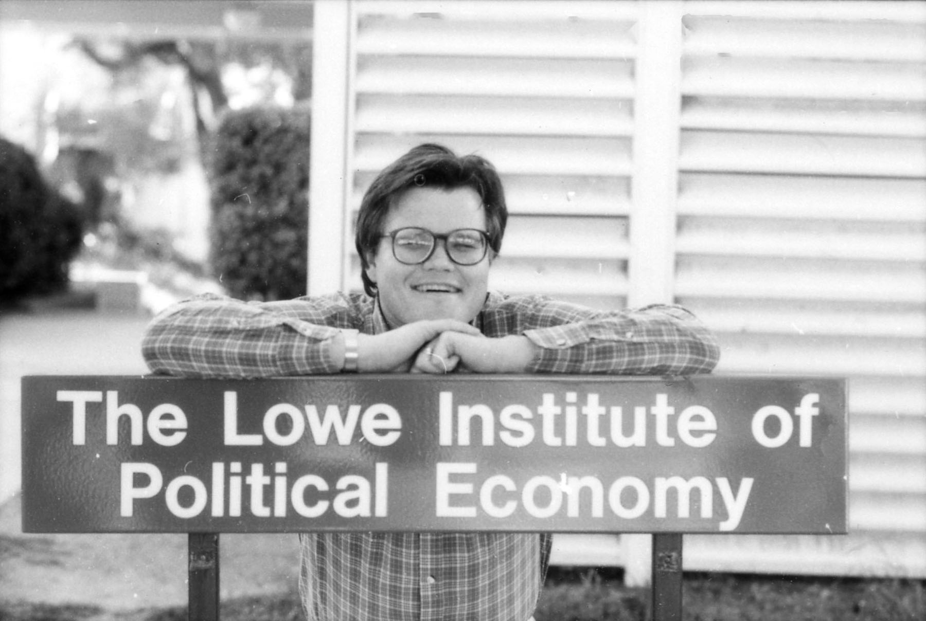 Professor Rodney Smith with Lowe Institute sign.