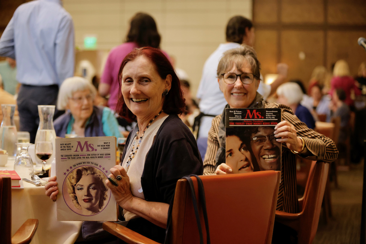 Participants hold up their copies of Ms Magazine at WLA's co-sponsored Ath event 