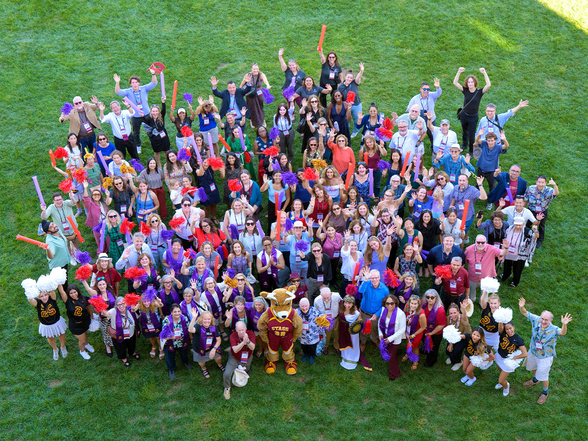 An aerial group shot of alumni during ImpactCMC 2026.