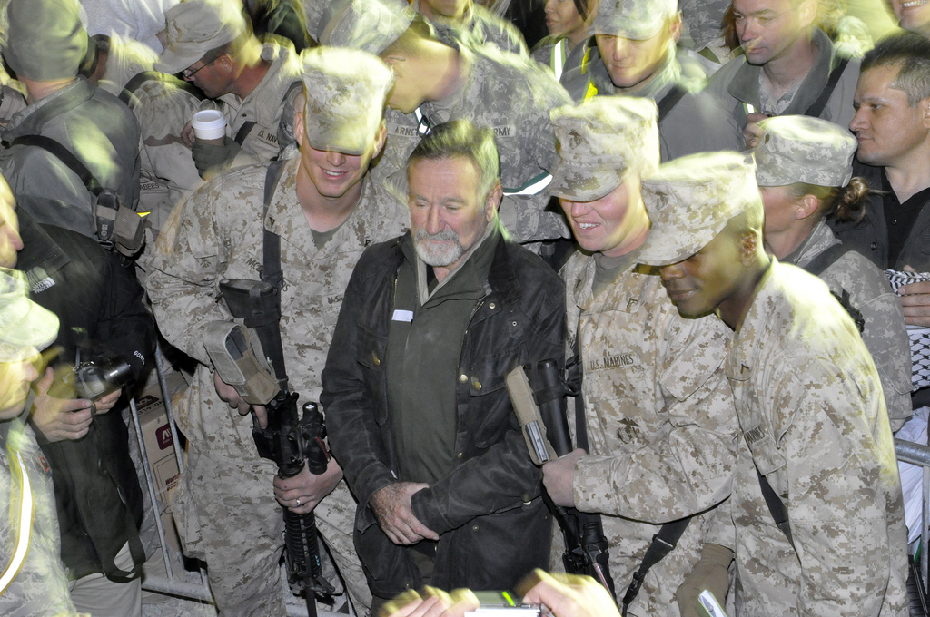 Robin Williams with U.S. Marines at a USO show in Afghanistan, December, 2010. Williams embraced the CMC ethos of service by giving his time, energy and talents to the troops.