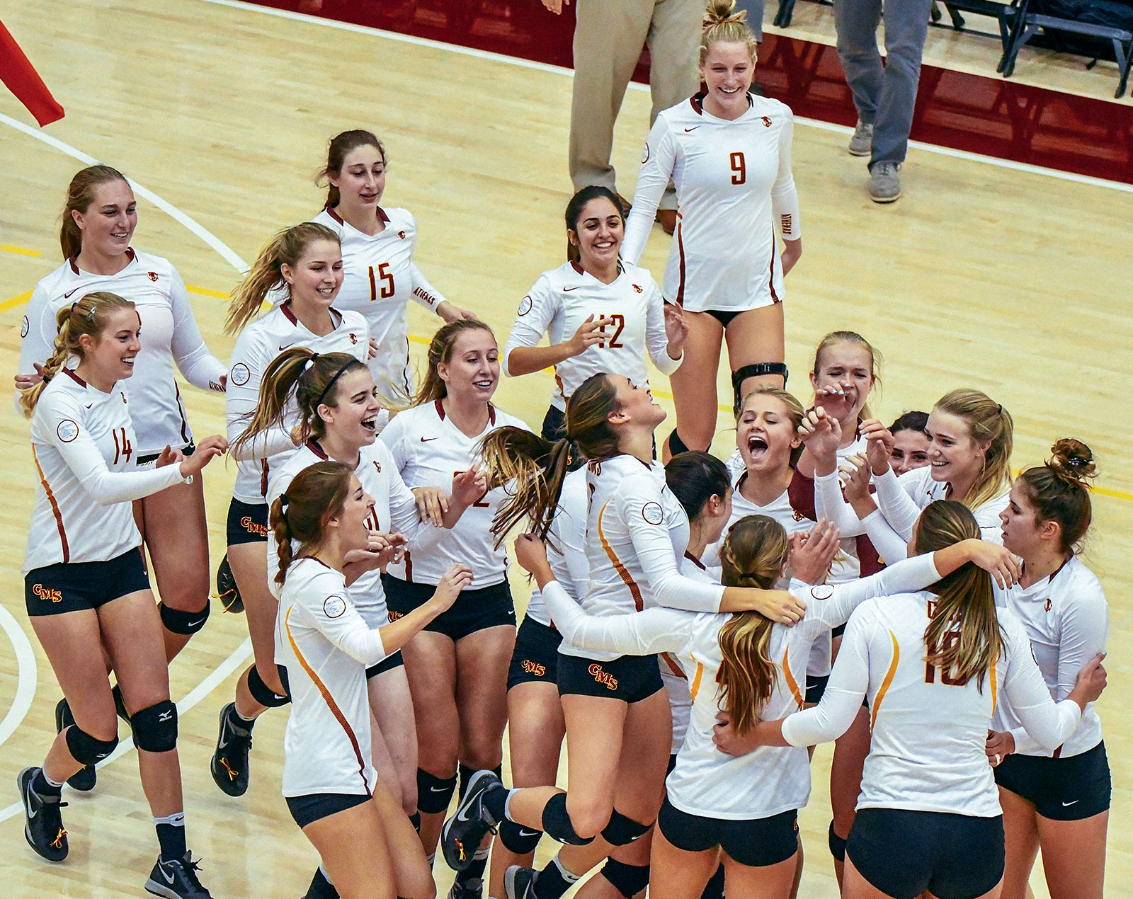 CMS volleyball team celebrates a victory