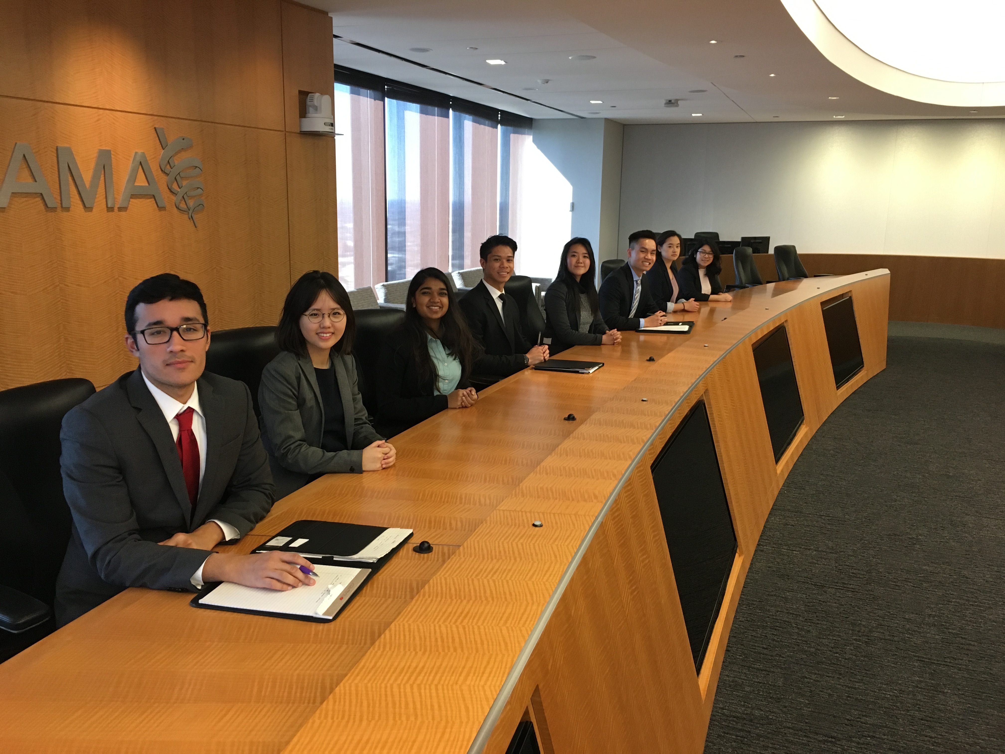 CMC students in the board room of a company in Chicago during their trip