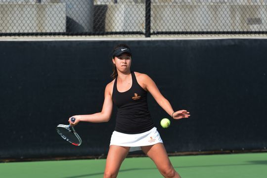 Tan playing tennis