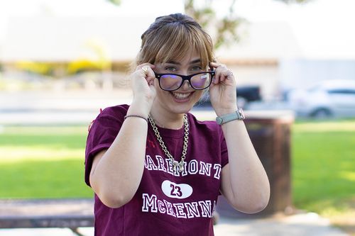 Kira Hirsch ’23, tries on a pair of blue light blocking glasses from her care package.