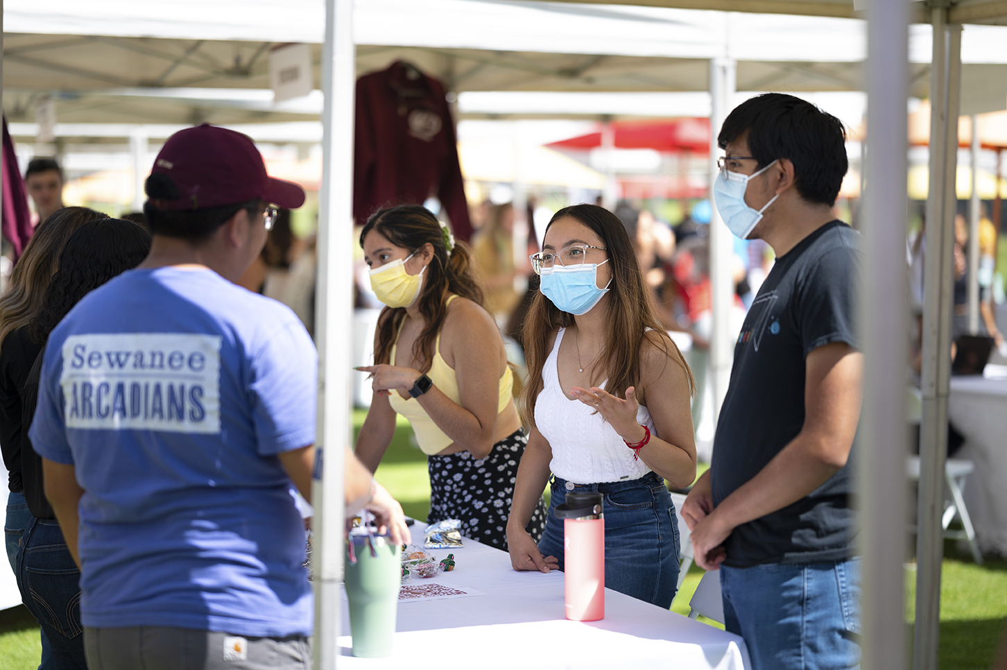 Sarai Ortega ’23 (left), Cassandra Hernandez ’24, and Jonathan Soriano ’23 talk to interested students at the QuestBridge booth.