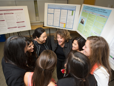 Shana Levin huddled with a group of students