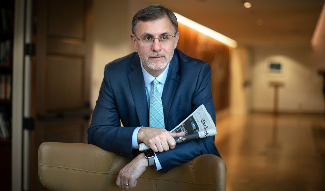 Michael Shear '90 leaning on chair