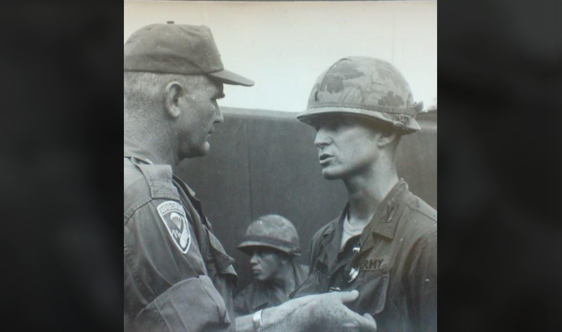 Black and white photo of Gilbert Ferrey '64 receiving a military award.