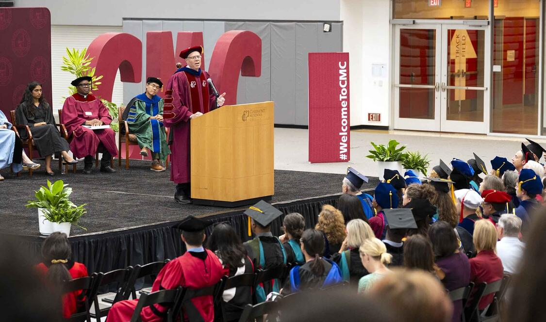 President Dudley at the podium in Roberts Pavilion during Convocation