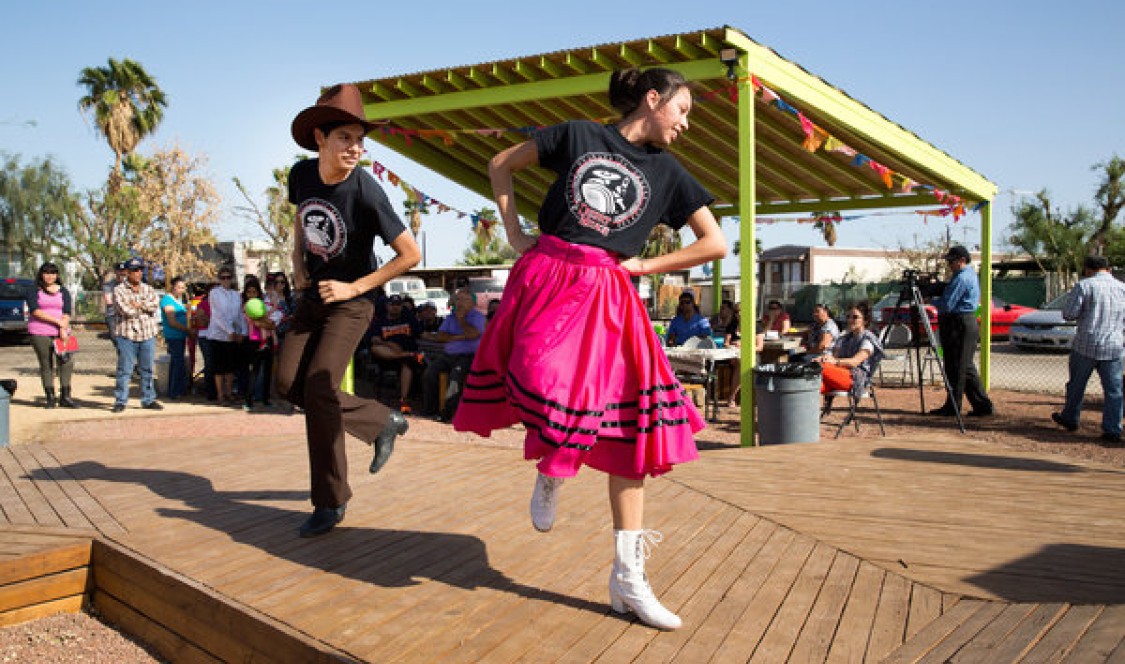 Two youths dance in a public square built by Kounkuey Design Initiative with local residents. The organization was co-founded by Chelina Odbert '99. Credit: Monica Almeida/The New York Times