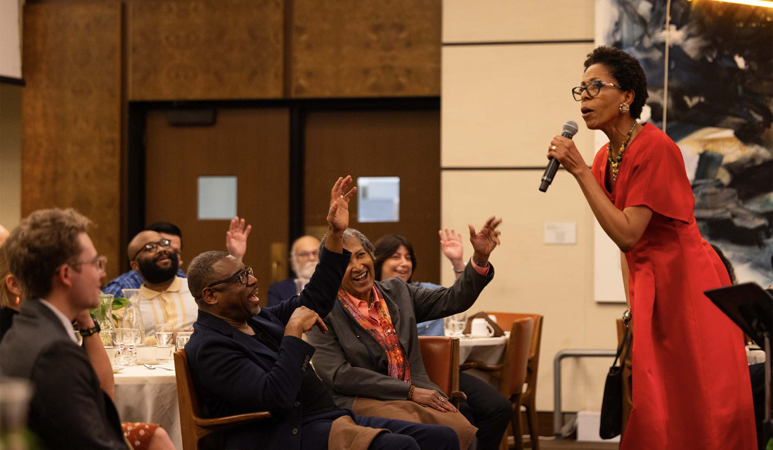 Dr. Diane White-Clayton in front of audience in the Ath