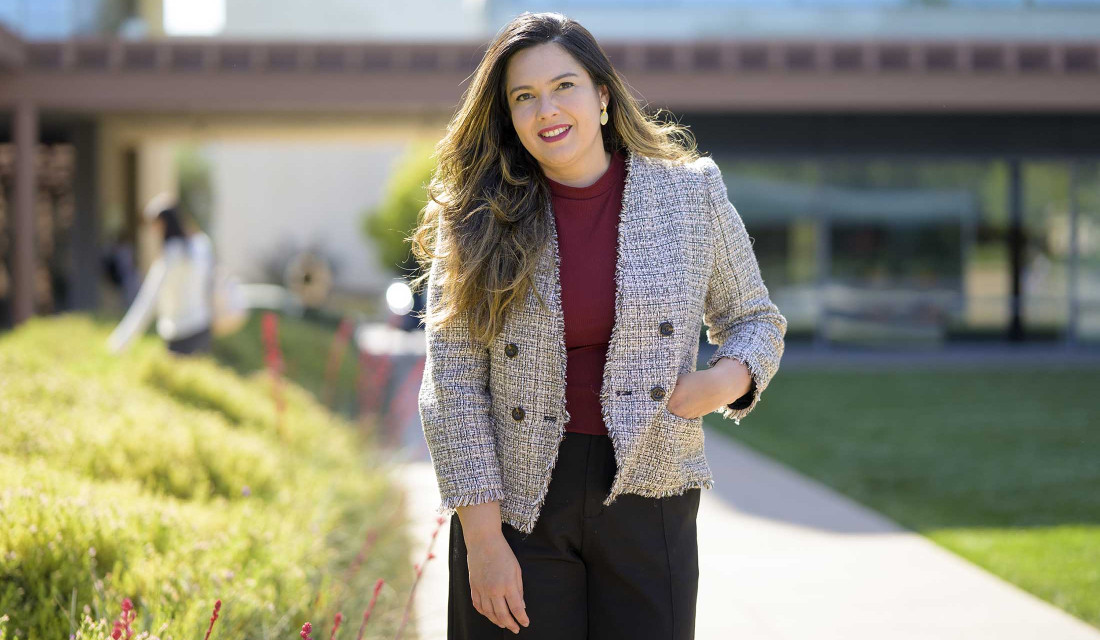 Professor Jennifer Feitosa photographed in Gann Quad on a sunny day.