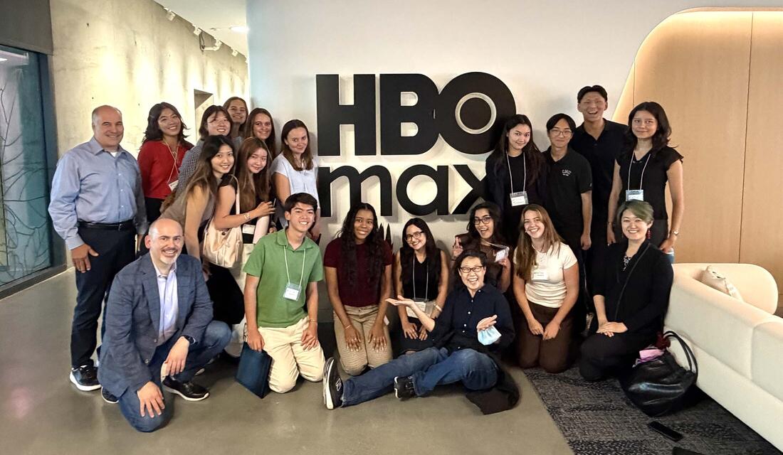 Group of students at networking trek in front of HBO sign