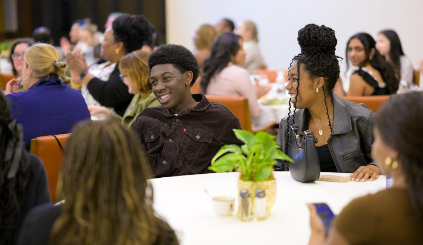 Students laughing in the Ath at the CARE Center anniversary celebration