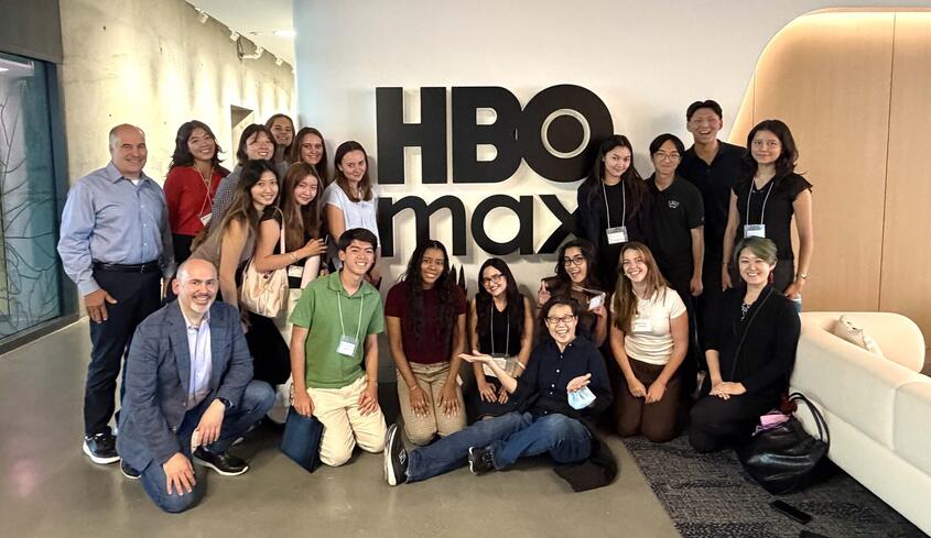 Group of students at networking trek in front of HBO sign