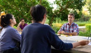 Cameron Shelton and students at a table